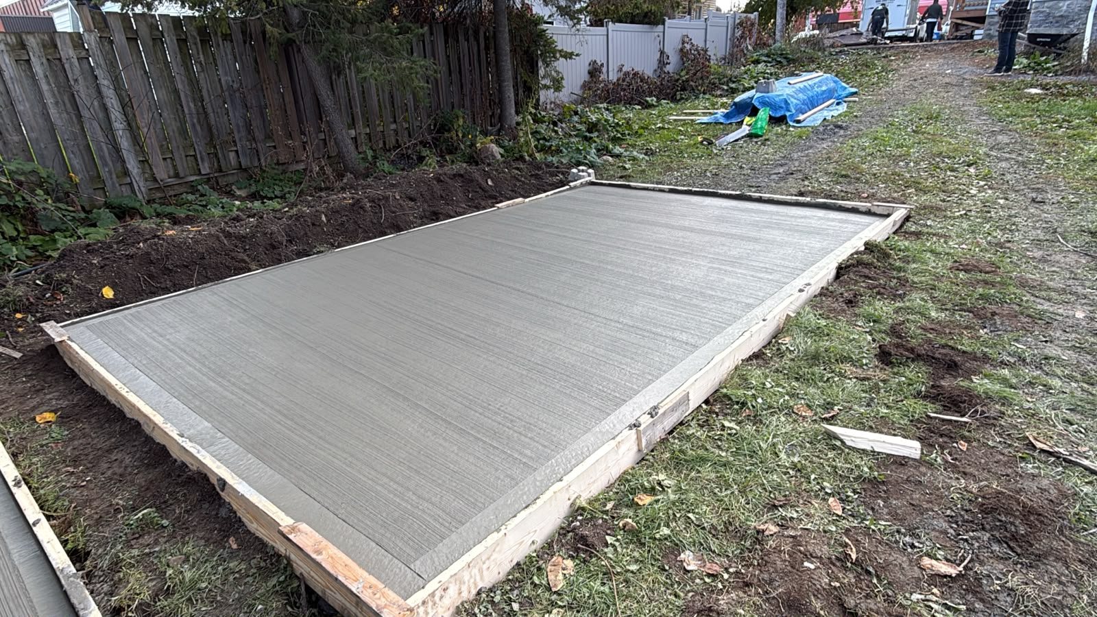 Freshly poured, broom-finished concrete slab